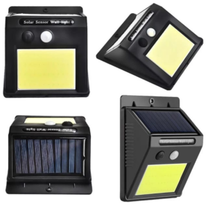 lámpara pequeña luz solar de pared negra con panel solar superior iluminando un sendero de jardín durante la noche